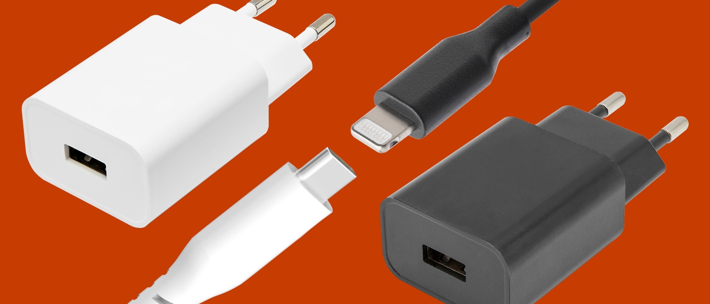 Hvit vegglader med EU-støpsel, svart USB-A-lader og kabler med USB-C og Lightning-kontakt mot oransje bakgrunn.