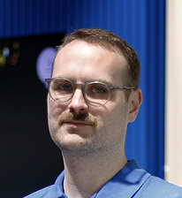 Person i blå pikétröja med Kjell & Company-logotyp