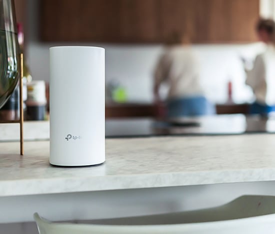 Moderne stue med en mesh wifi-ruter plassert på bordet blant hjemmedekorasjon, illustrerer stabil trådløs dekning i hjemmet